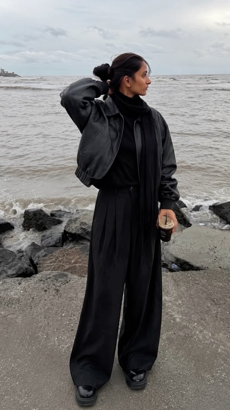 All-black outfit with leather jacket and wide-leg trousers