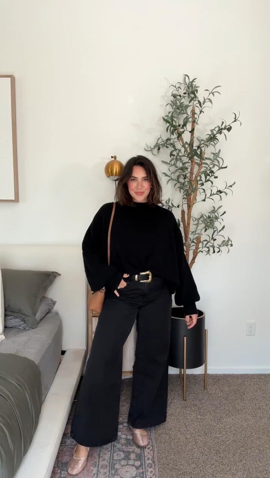Black oversized sweater with wide-leg trousers and gold belt