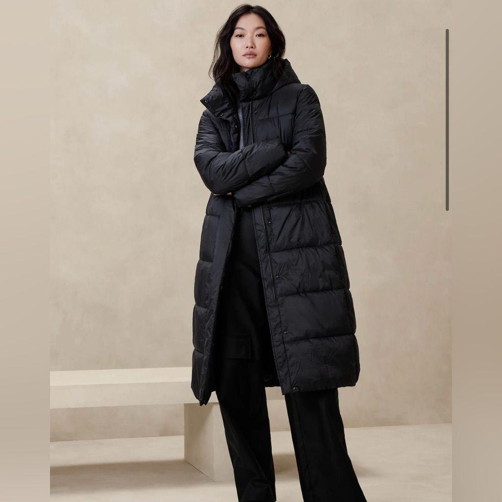 Woman in long black puffer coat with wide-leg trousers