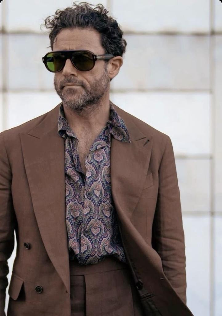 Man in brown blazer with paisley shirt