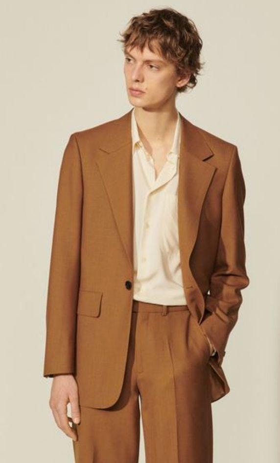 Man in brown suit with cream shirt