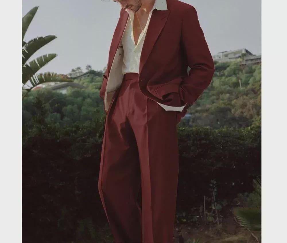 Man in burgundy suit outdoors