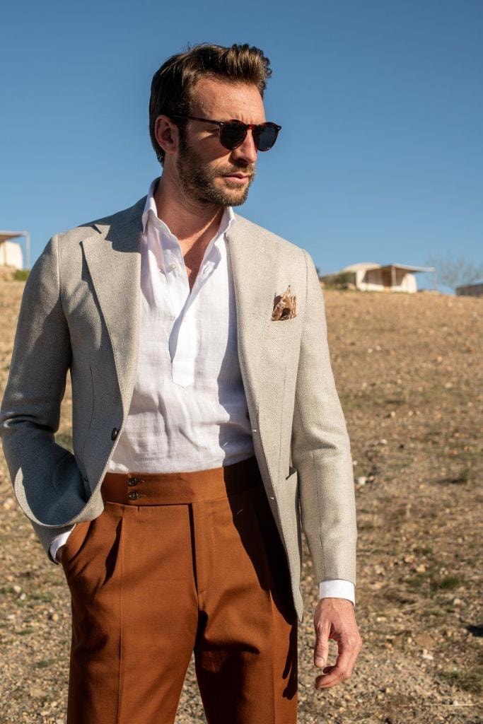Man in linen blazer with rust trousers