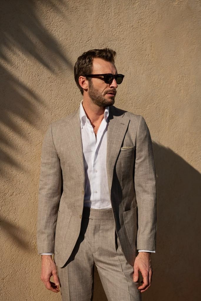 Man in tan suit with sunglasses